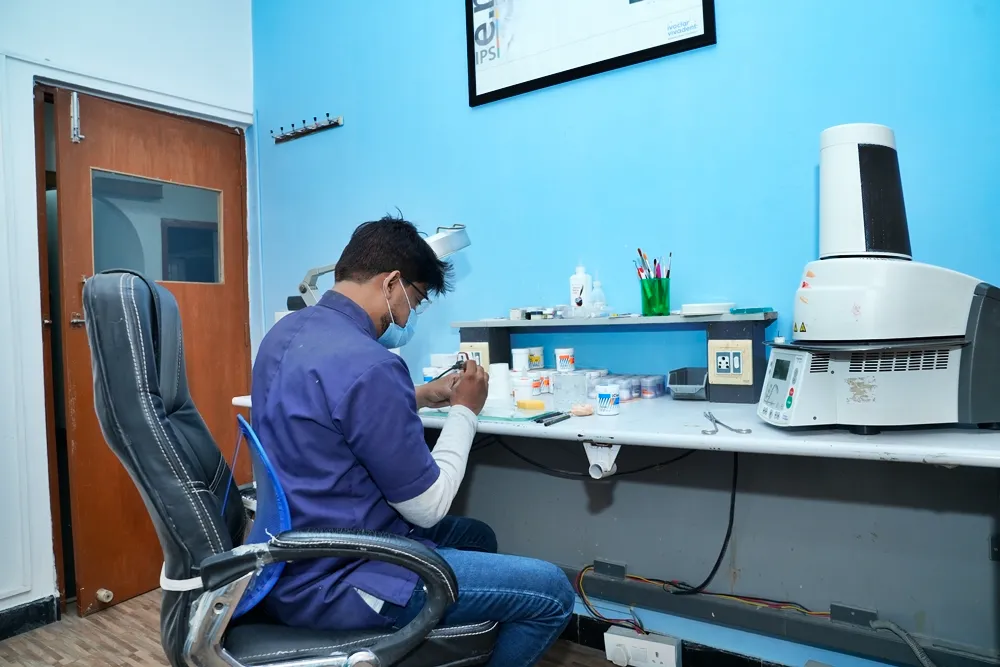 Lab technician crafting restorations